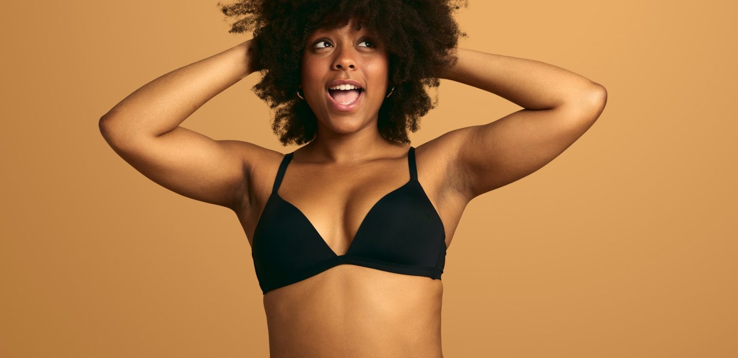 Cheerful black woman in underwear